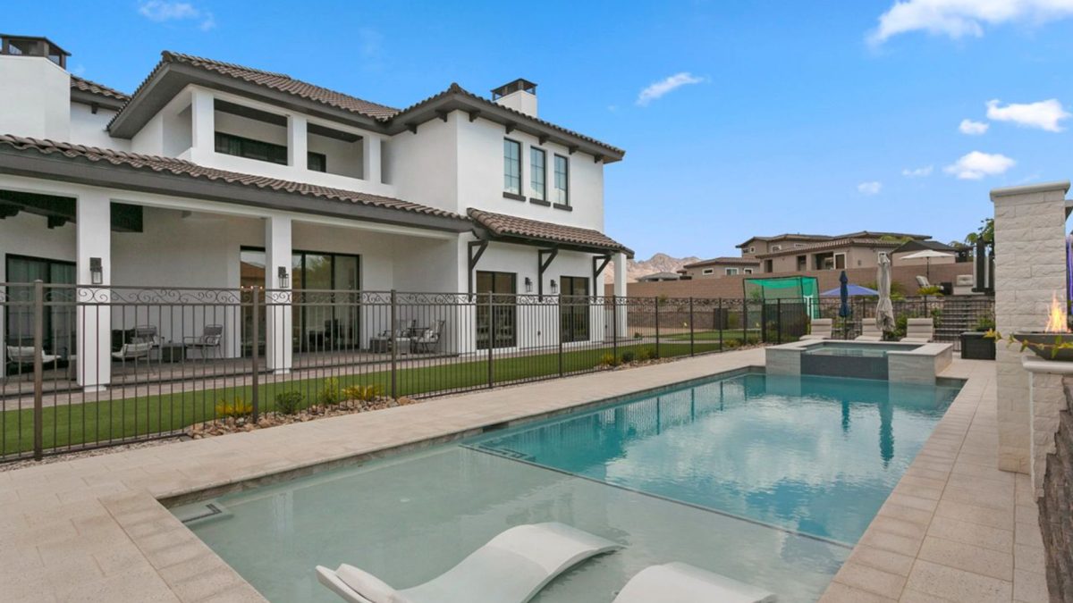 A resort style pool in a luxury home's backyard