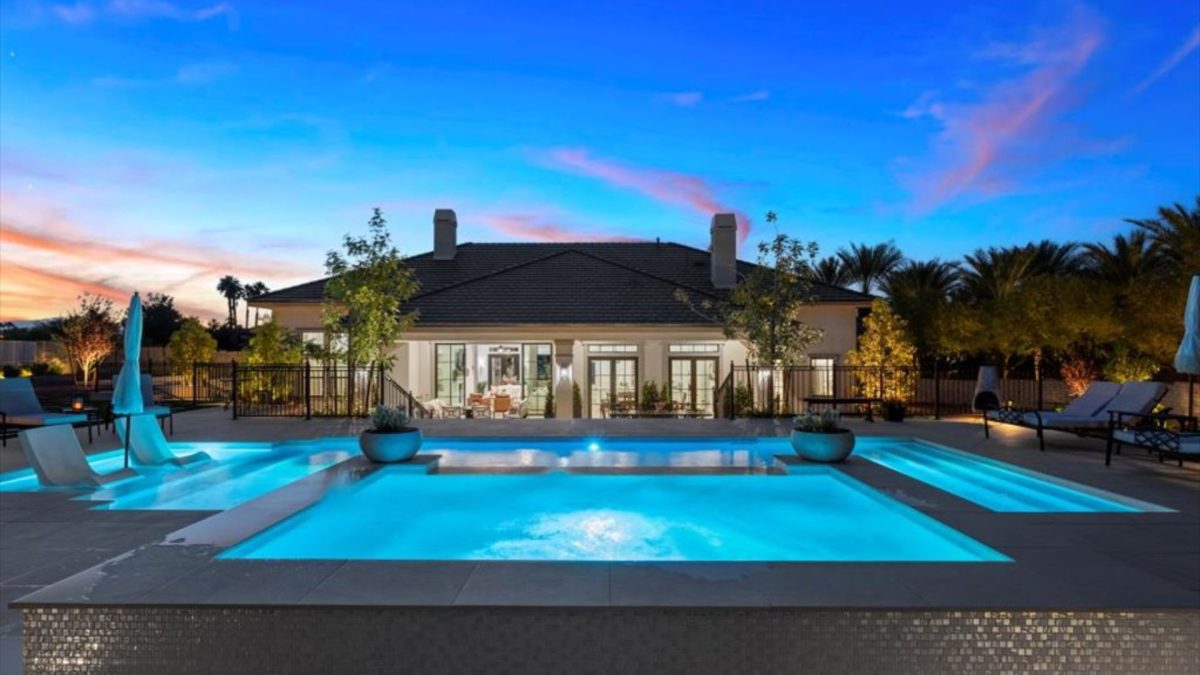 Large home with custom pool that's lighted.