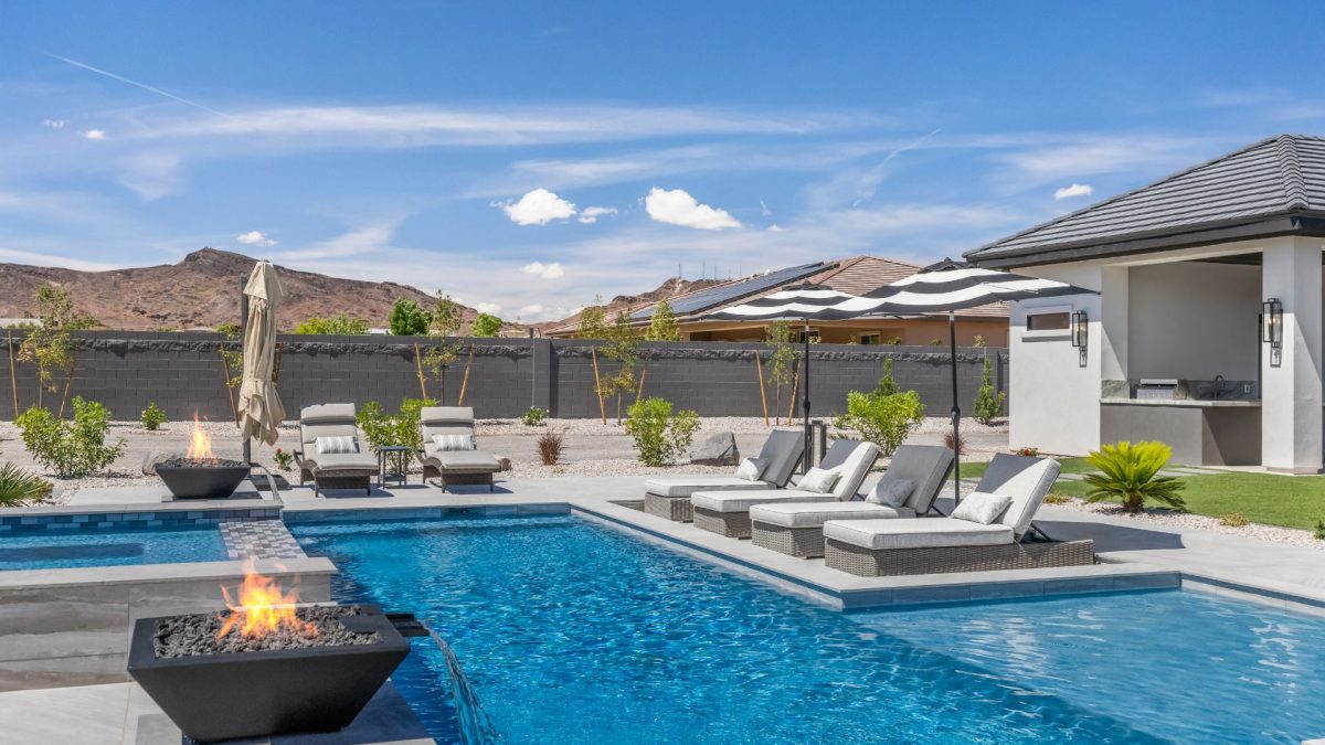 Swimming Pool with water features and umbrellas next to loungers
