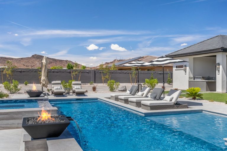 Swimming Pool with water features and umbrellas next to loungers